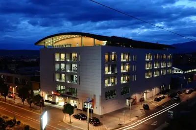 a large white building with a dome on top of it at Ramada by Wyndham Podgorica in Podgorica