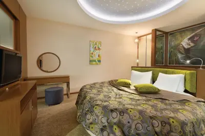 a bedroom with a bed and a flat screen tv at Ramada by Wyndham Podgorica in Podgorica