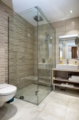 a bathroom with a shower and a toilet and a sink at Hotel Fobra in Podgorica
