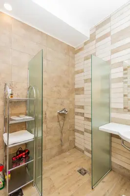 a shower with a glass door in a bathroom at Hotel Fobra in Podgorica