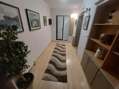 a room with a hallway with a rug on the floor at Hotel Fobra in Podgorica