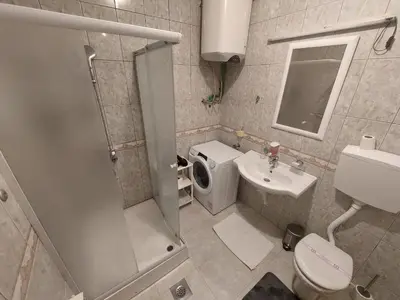 a bathroom with a shower and a toilet and a sink at Hotel Fobra in Podgorica