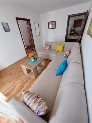 a large couch with pillows in a living room at Apartments South in Ulcinj