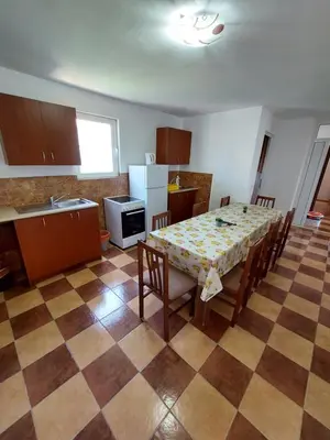 a kitchen with a table and chairs and a kitchen with at Apartments South in Ulcinj
