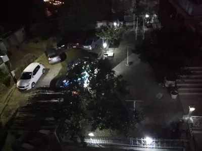 a white car parked in a parking lot at night at Apartments South in Ulcinj