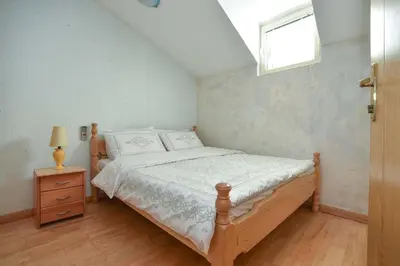 a bedroom with a wooden bed and a window at Comfort Inn Old Town in Budva