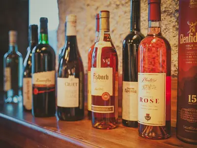 a bunch of bottles of wine sitting on a table at Pansion Nobel in Petrovac na Moru