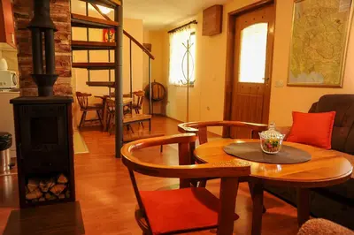 a living room with a table and a wood stove at LOVCEN4ME in Cetinje