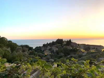 a view of a town from a hill at sunset at Reževići Apartments in Petrovac na Moru