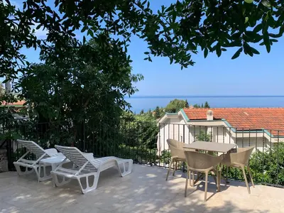a group of chairs and a table on a patio at Reževići Apartments in Petrovac na Moru