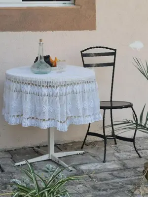 a table with a chair and a vase on it at Apartments Coso Zlatne njive bb in Kotor