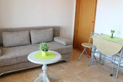 a living room with a couch and a table at Apartments Villa Milna 2 in Budva