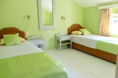 a bedroom with two beds and a mirror at Apartments Villa Milna 2 in Budva