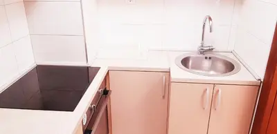 a small kitchen with a sink and a mirror at Olimp Lux in Budva