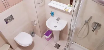 a bathroom with a sink and a shower and a toilet at Olimp Lux in Budva
