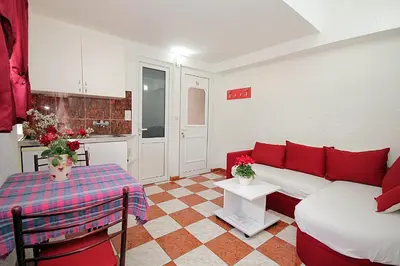 a living room with a couch and a table at Apartments Kruna Jovanović in Sutomore