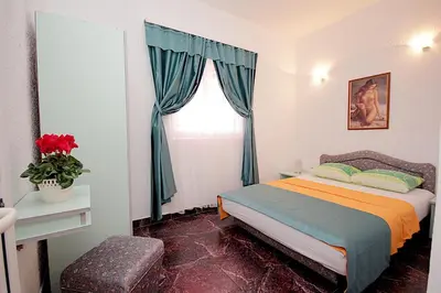 a bedroom with a bed and a window at Apartments Kruna Jovanović in Sutomore