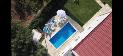 an overhead view of a swimming pool next to a red building at Zelena Maslina in Bar
