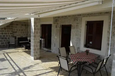 a patio with a table and chairs on a patio at Vila Nikola in Bratesici