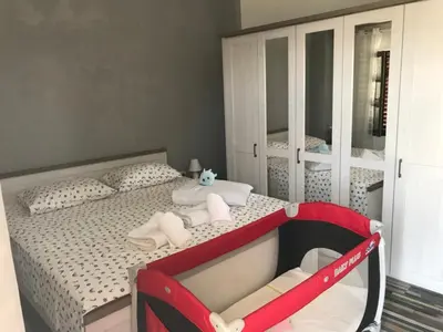 a bedroom with a bed with a red crib at Vila Nikola in Bratesici