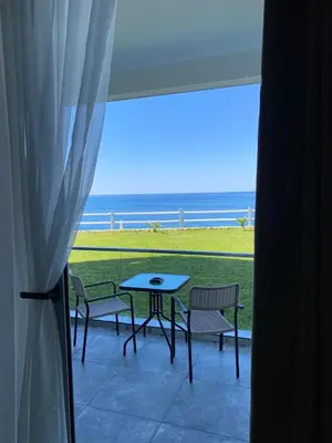 a patio with a table and chairs and a view of the ocean at Apartments Komina in Utjeha