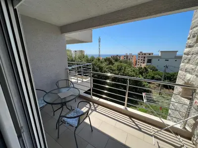 a balcony with a table and chairs and a view at Villa Dobre Vode in Dobra Voda