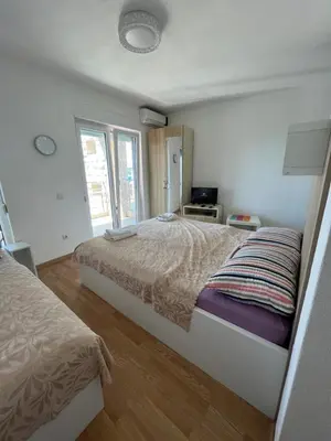 a bedroom with two beds and a window at Villa Dobre Vode in Dobra Voda