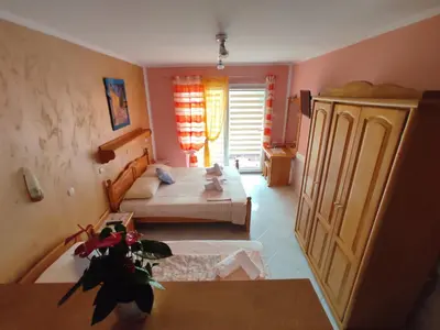 a small room with two beds and a table at Villa Aleksandra - T in Rafailovici