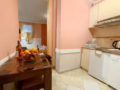 a kitchen with a bowl of fruit on a table at Villa Aleksandra - T in Rafailovici