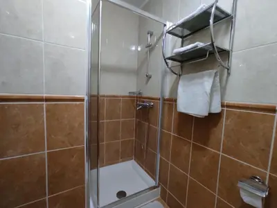 a shower with a glass door in a bathroom at Villa Aleksandra - T in Rafailovici