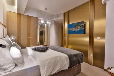 a bedroom with a large white bed with white pillows at Hotel Fagus by Aycon in Budva