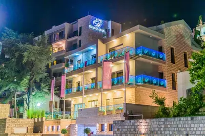 a building with blue lights in front of it at Hotel Butua Residence in Budva