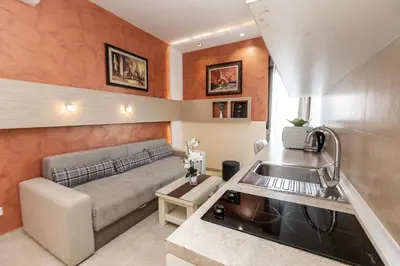 a kitchen and living room with a couch and a sink at Hotel Butua Residence in Budva