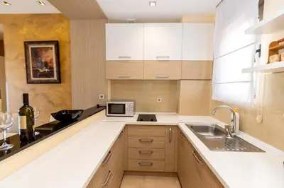 a kitchen with a sink and a microwave at Hotel Butua Residence in Budva