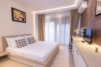 a hotel room with a bed and a television at Hotel Butua Residence in Budva