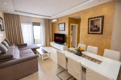 a living room with a couch and a dining room at Hotel Butua Residence in Budva