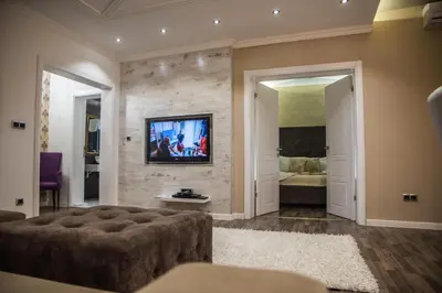 a living room with a couch and a tv on a wall at Hotel RESIDENCE in Ulcinj
