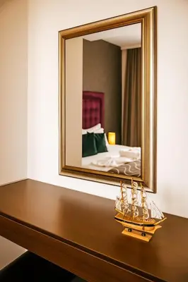 a mirror on top of a table in a bedroom at Hotel RESIDENCE in Ulcinj