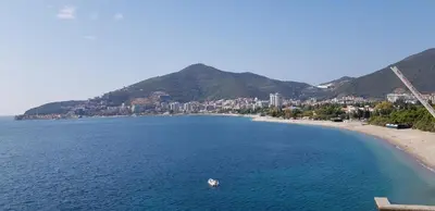 a view of a beach with a boat in the water at The Magic Sea View Apartments in Budva