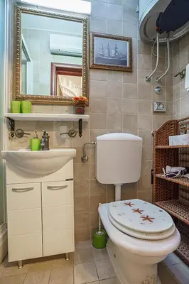 a bathroom with a toilet and a sink and a mirror at Apartments Wine House Old Town in Kotor