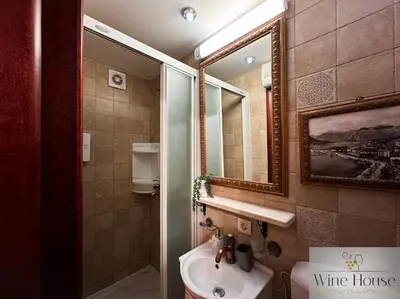 a bathroom with a sink and a mirror at Apartments Wine House Old Town in Kotor
