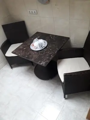 a black table with two chairs and a plate on it at Centar Budva in Budva