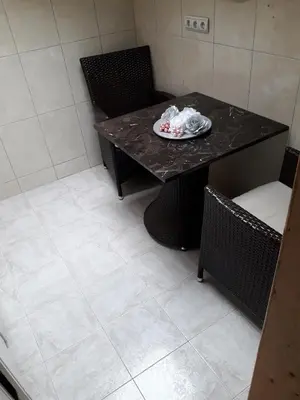a table and chairs with a plate on it at Centar Budva in Budva
