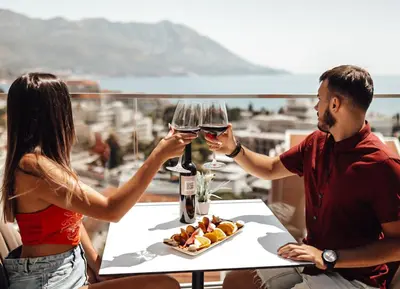 a man and a woman holding glasses of wine at Hotel Lusso Mare by Aycon in Budva