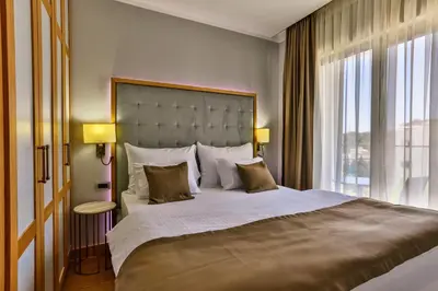 a bedroom with a large bed with a large window at Hotel Lusso Mare by Aycon in Budva