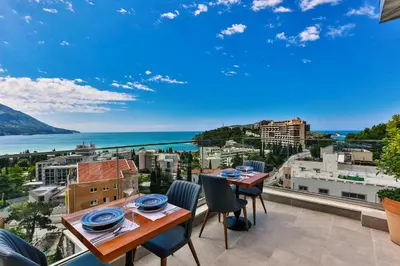 a table and chairs on a balcony with a view of the ocean at Hotel Lusso Mare by Aycon in Budva