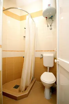 a bathroom with a toilet and a shower at Apartments Radosavovic in Bar