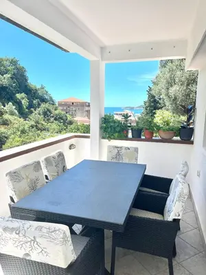 a table and chairs on a balcony with a view at Apartments Harmonija in Budva