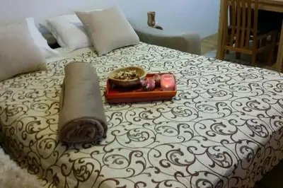 a bed with a tray with candles on it at Apartments Maljevic Maca in Bar