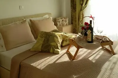 a bedroom with a bed with a table next to it at Apartments Maljevic Maca in Bar